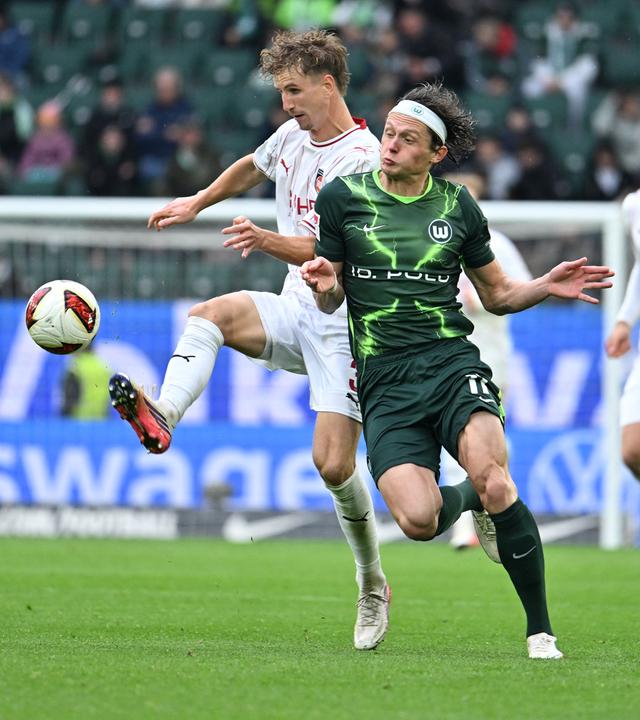 Fabian Reese (r, VfL Wolfsburg) kämpft mit Jan Schöppner (l, 1. FC Heidenheim) um den Ball am 17.10.2026 in Wolfsburg.
