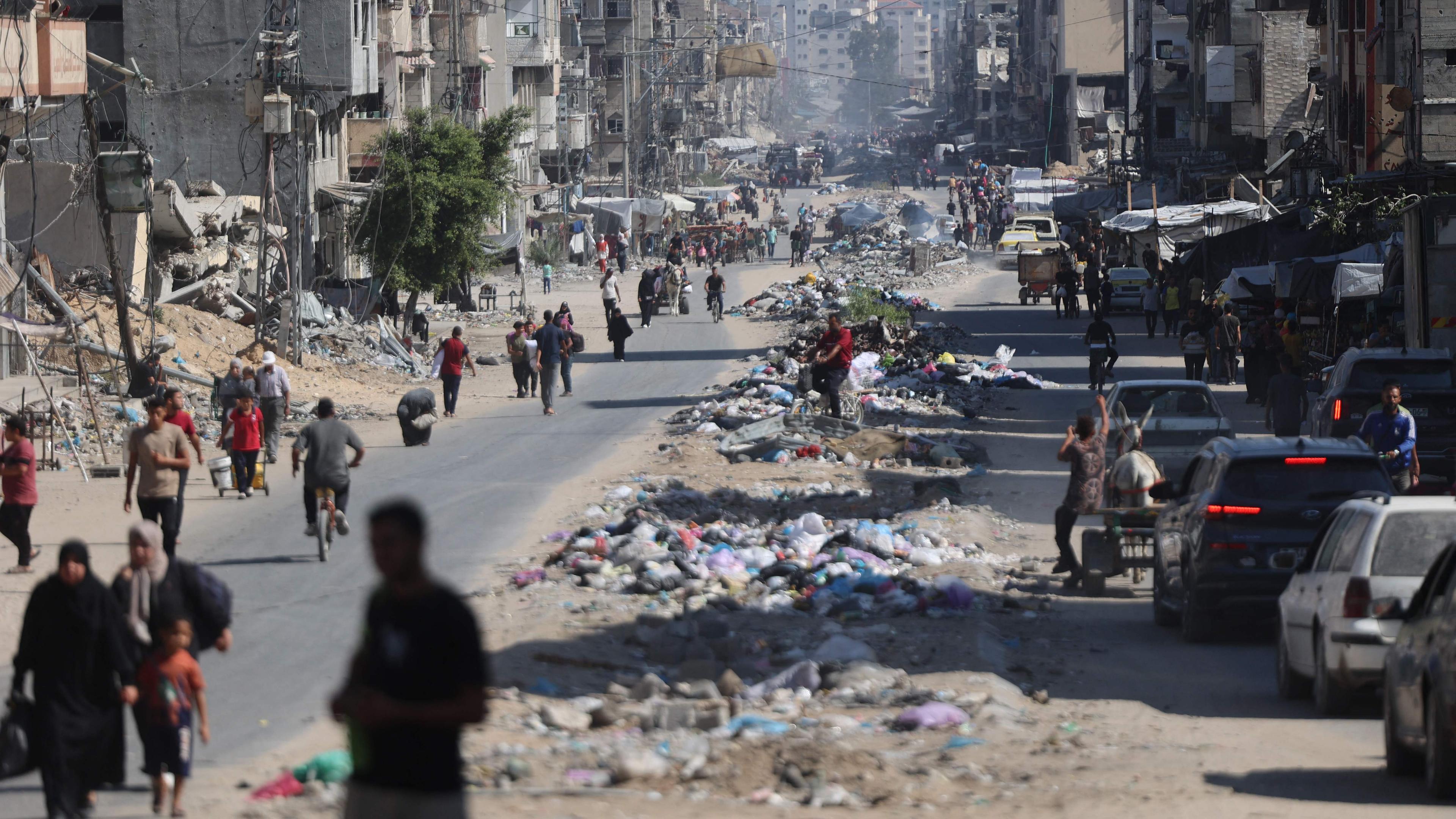 Palestinians carry their belongings as they flee areas north of Gaza City in the northern Gaza Strip on October 12, 2024. In recent days, the military has launched an intense ground and air assault in northern Gaza, particularly in and around the city of Jabalia.