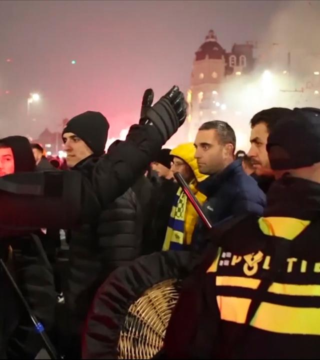 n this image taken from video, police escort Maccabi Tel Aviv supporters to the metro station leading them to the Ajax stadium, after pro-Palestinian supporters marched near the stadium, in Amsterdam, the Netherlands