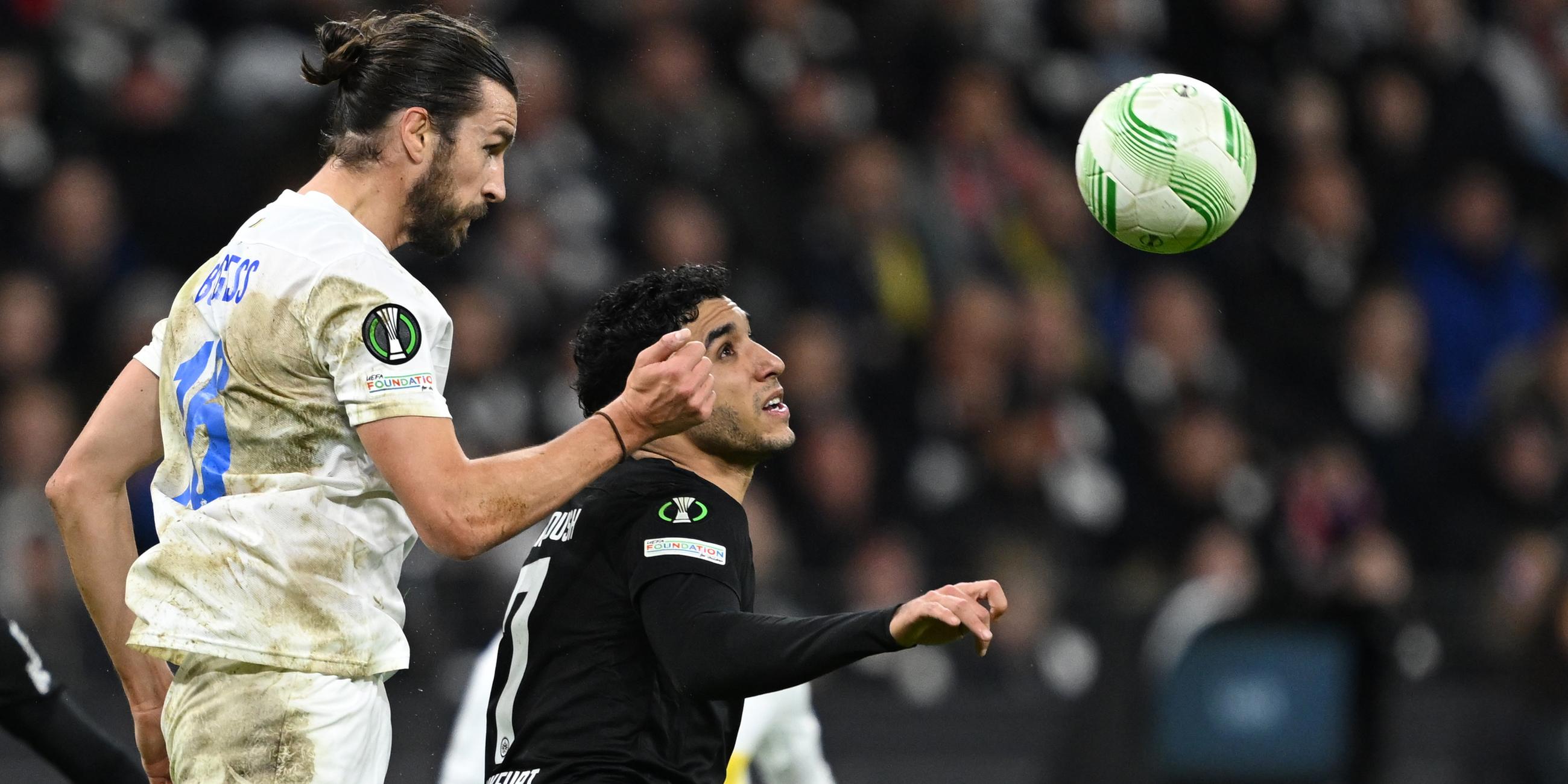 Unions Christian Burgess und Frankfurts Omar Marmoush (r) kämpfen um den Ball. 