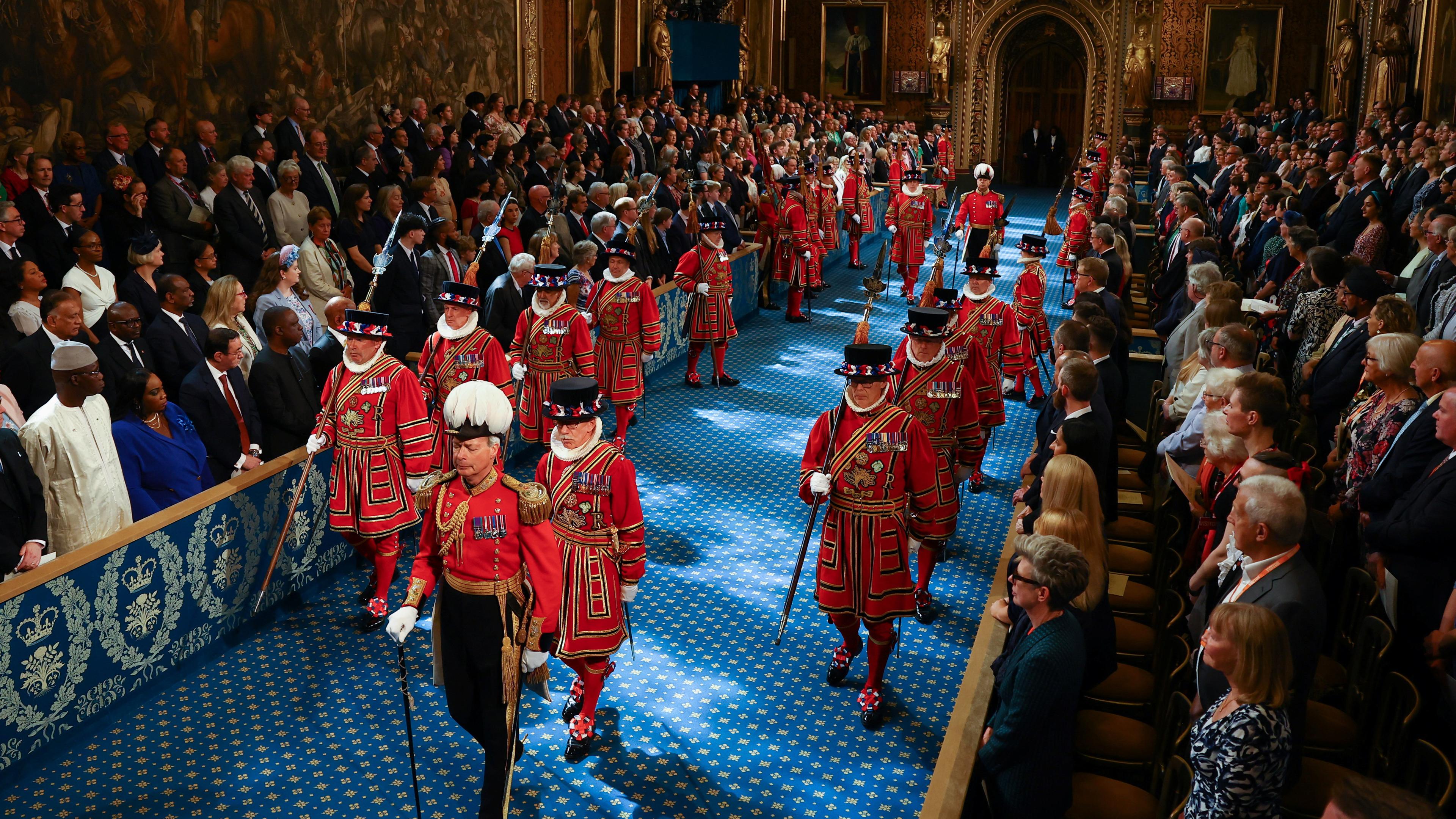 17.07.2024, Großbritannien, London: Die Leibgarde des Königs, die Yeomen of the Guard, schreiten am Tag der Parlamentseröffnung durch die Royal Gallery im House of Lords im Palace of Westminster. 