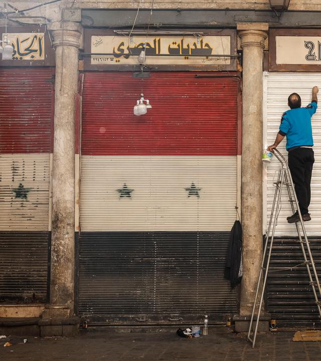 A man paints the railings of his establishment in Damascus, Syria, 13 December 2024. Hay'at Tahrir Al-Sham (HTS) leader Abu Mohammad Al-Jolani called on people across the country to celebrate 'the victory of the revolution' on 13 December, following the capture of Damascus and the overthrow of Bashar al-Assad