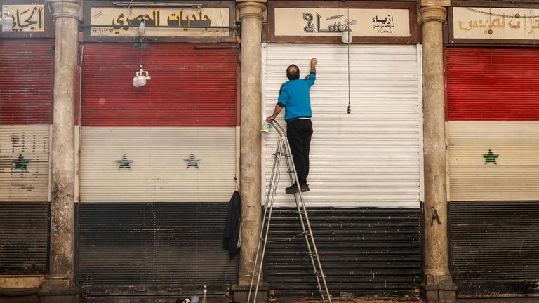 A man paints the railings of his establishment in Damascus, Syria, 13 December 2024. Hay'at Tahrir Al-Sham (HTS) leader Abu Mohammad Al-Jolani called on people across the country to celebrate 'the victory of the revolution' on 13 December, following the capture of Damascus and the overthrow of Bashar al-Assad