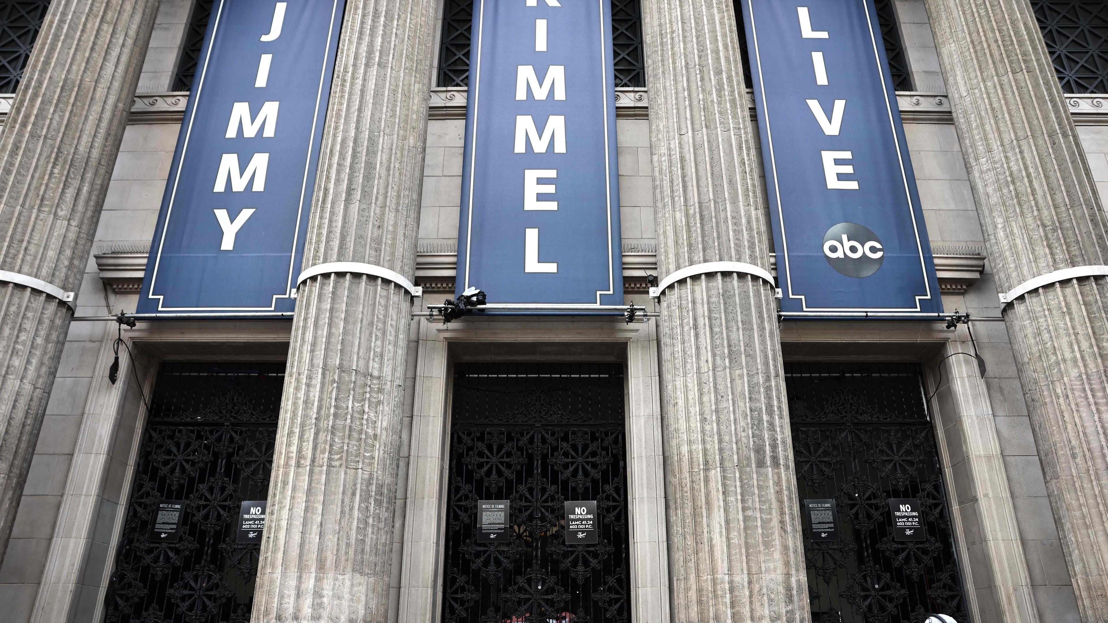 LOS ANGELES, CALIFORNIA - SEPTEMBER 18: A person walks past the El Capitan Entertainment Centre where the "Jimmy Kimmel Live!" show is performed in Hollywood on September 18, 2025 in Los Angeles, California.