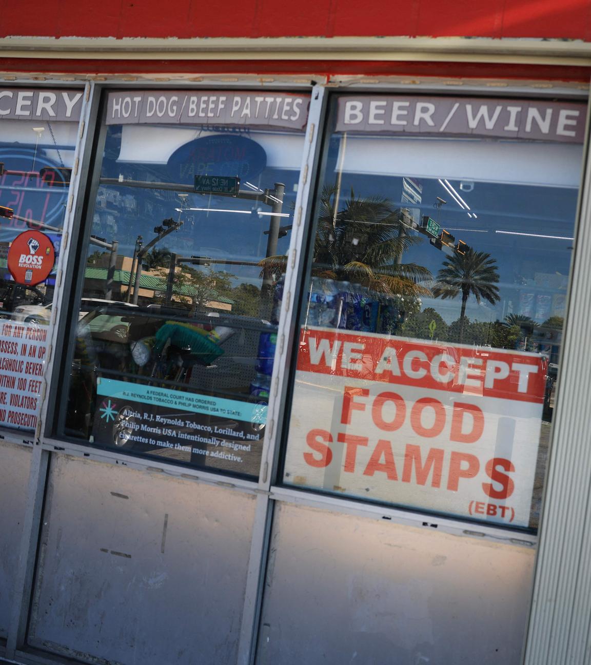 A 'We Accept Food Stamps' sign hangs in the window of a grocery store on October 31, 2025 in Miami, Florida. 
