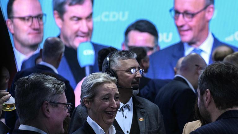 Co-leader of Germany's far-right Alternative for Germany (AfD) party and main candidate Alice Weidel (C) talks with party members as Leader of Germany's Christian Democratic Union (CDU)