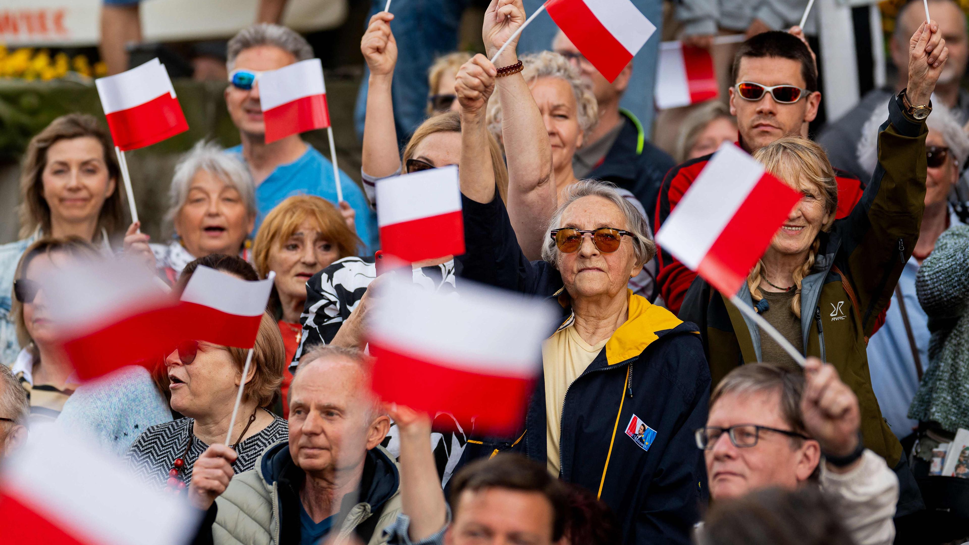 Anhänger schwenken polnische Fahnen für den Präsidentschaftskandidaten, Warschaus Bürgermeister und Mitglied der regierenden bürgerlichen Koalitionspartei Rafal Trzaskowski während seiner letzten politischen Kundgebung in Danzig, Nordpolen, am 30. Mai 2025, vor der zweiten Runde der Präsidentschaftswahlen am 1. Juni.