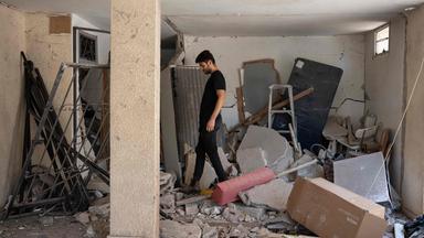 A man walks amid debris in a building hit during an Iranian missile strike in Haifa, on June 17, 2025. Israel and Iran traded deadly fire for a fifth day on June 17 in their most intense confrontation in history, fuelling fears of a drawn-out conflict that could engulf the Middle East.
