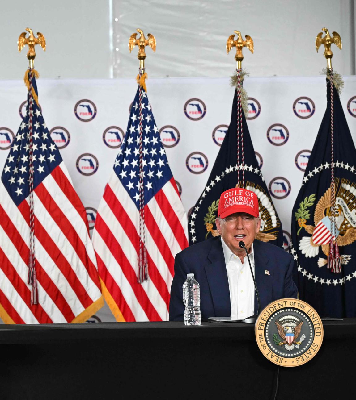 US President President Donald Trump speaks as US Secretary of Homeland Security Kristi Noem (L) looks on after touring a migrant detention center, dubbed "Alligator Alcatraz," located at the site of the Dade-Collier Training and Transition Airport in Ochopee, Florida on July 1, 2025.