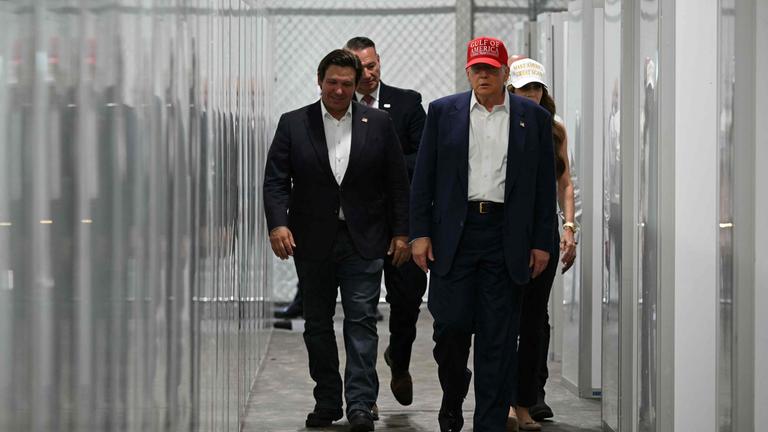 US President President Donald Trump visits a detention center located in the Florida Everglades
