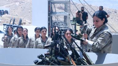 Kämpfer der Arbeiterpartei Kurdistans (PKK) stellen sich während einer Zeremonie in Sulaimaniyah in der autonomen Region Kurdistan im Irak am 11. Juli 2025 auf, um ihre Waffen in eine Grube zu legen.