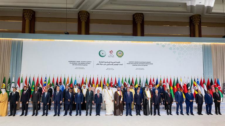 This handout picture released by the he Qatar News Agency (QNA) shows Qatar's Emir Sheikh Tamim bin Hamad Al-Thani (C) posing for a group picture with leaders, heads of state and other officials during the 2025 Arab-Islamic emergency summit in Doha on September 15, 2025
