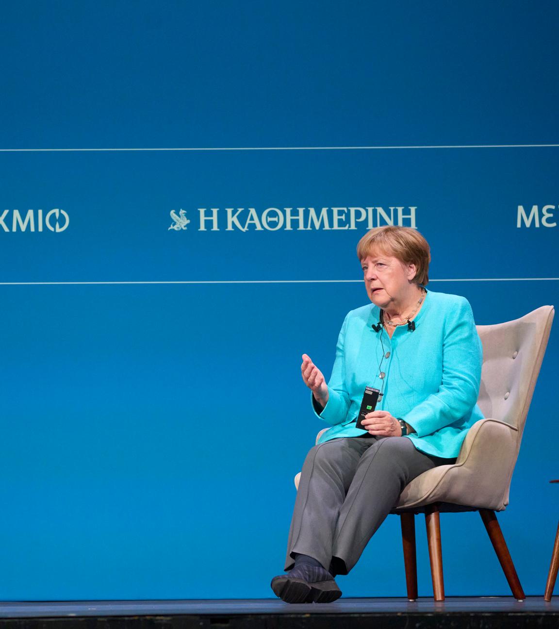 Former German Chancellor Angela Merkel, right, answers a question to Executive Editor of Kathimerini newspaper Alexis Papahelas during the presentation of her book "Freedom"