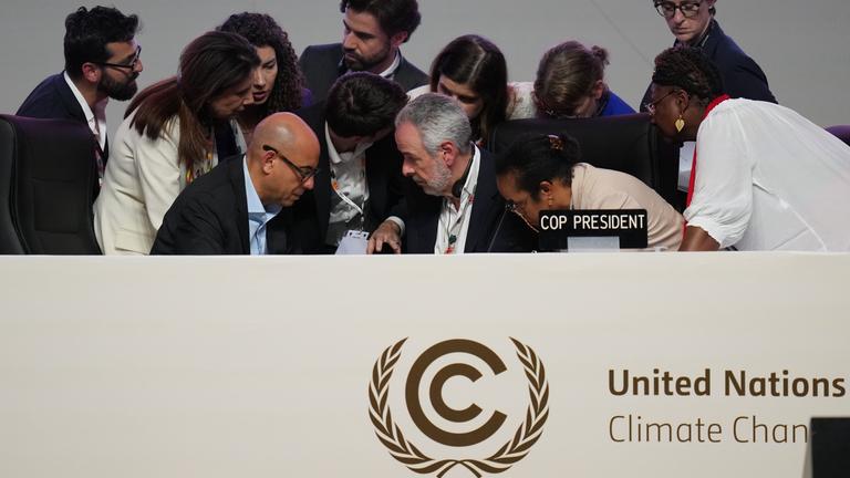 André Corrêa do Lago, COP30 president, center, and Simon Stiell, United Nations climate chief, front left, speak with staff during a plenary session at the COP30 U.N. Climate Summit, Saturday, Nov. 22, 2025, in Belem, Brazil.