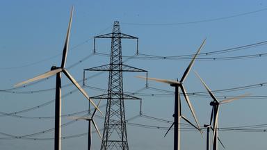  Little Cheyne Court Wind Farm amongst existing electricity pylons on the Romney Marsh in Kent