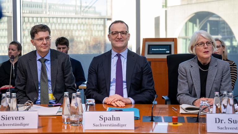 Jens Spahn (M), Vorsitzender der CDU/CSU-Bundestagsfraktion und früherer Bundesgesundheitsminister, sitzt vor Beginn der öffentlichen Anhörung der Enquete-Kommission des Bundestages zur Aufarbeitung der Corona-Pandemie neben Oliver Sivers (l), Mitglied des Bundesrechnungshofes und Leiter des Prüfgebietes IX 1, und Margaretha Sudhof, Sonderermittlerin des Ministeriums zu Maskenbeschaffungen.