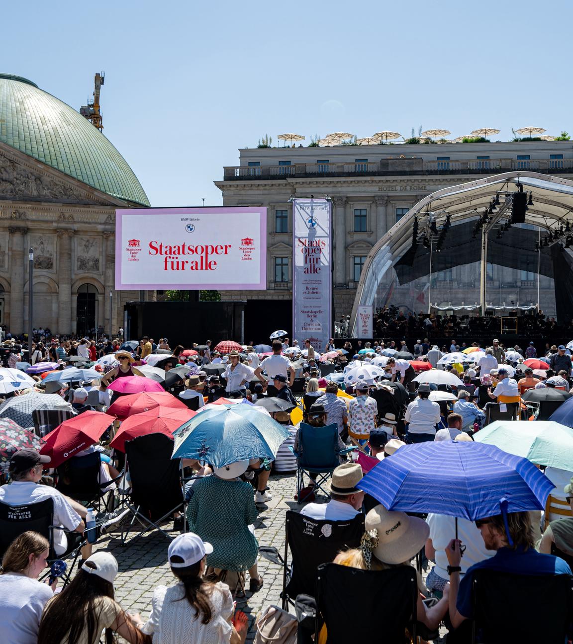 22.06.2025, Berlin: Menschen verfolgen bei hohen Temperaturen das Open-Air Konzert der «Staatsoper für alle» der Staatskapelle Berlin.