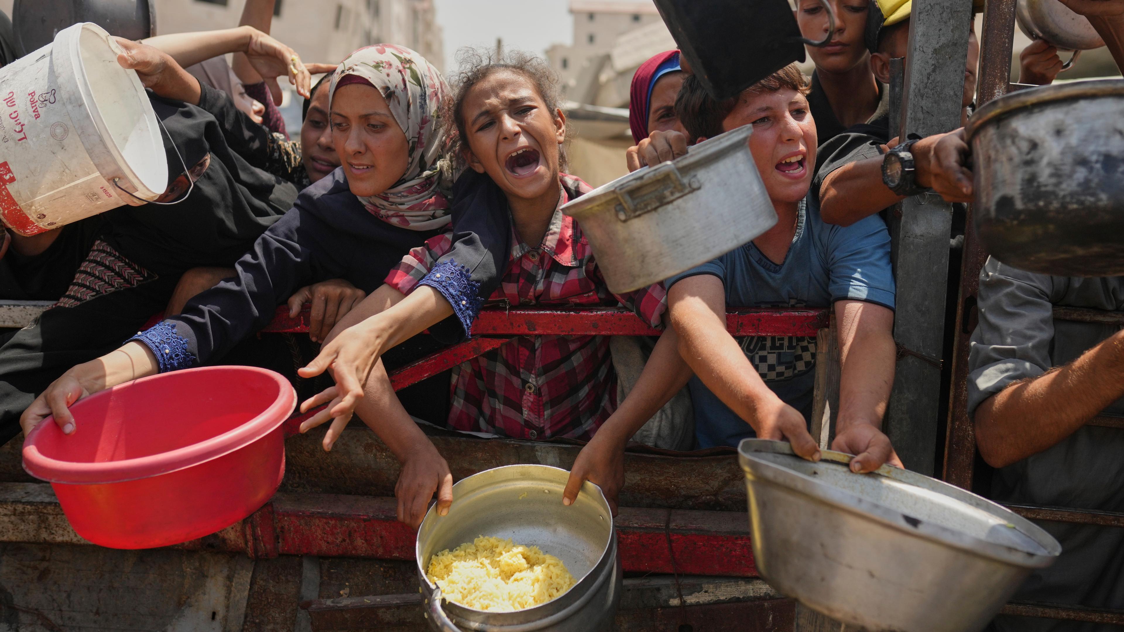  Palästinensische Gebiete, Gaza: Palästinenser kämpfen um gespendete Lebensmittel in einer Gemeinschaftsküche im nördlichen Gazastreifen.
