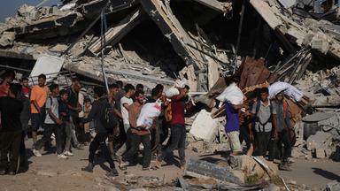 Palästinenser tragen humanitäre Hilfspakete in der Nähe des Verteilungszentrums der Gaza Humanitarian Foundation, das von der von den USA unterstützten Organisation im südlichen Gazastreifen betrieben wird.