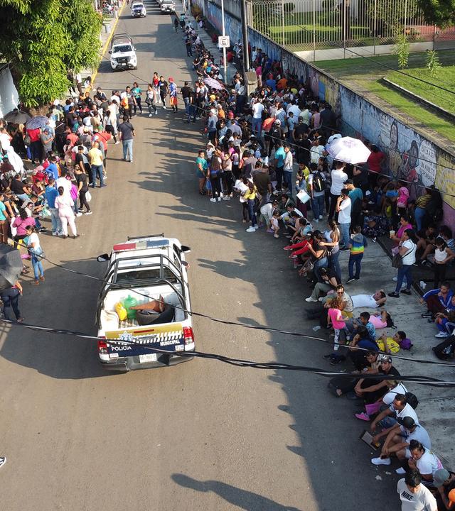 Migrants wait at Mexico's southern border after Trump's new migration measures