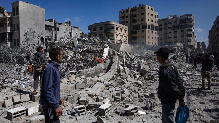 Palestinians inspect the rubble after renewed Israeli airstrikes on Gaza