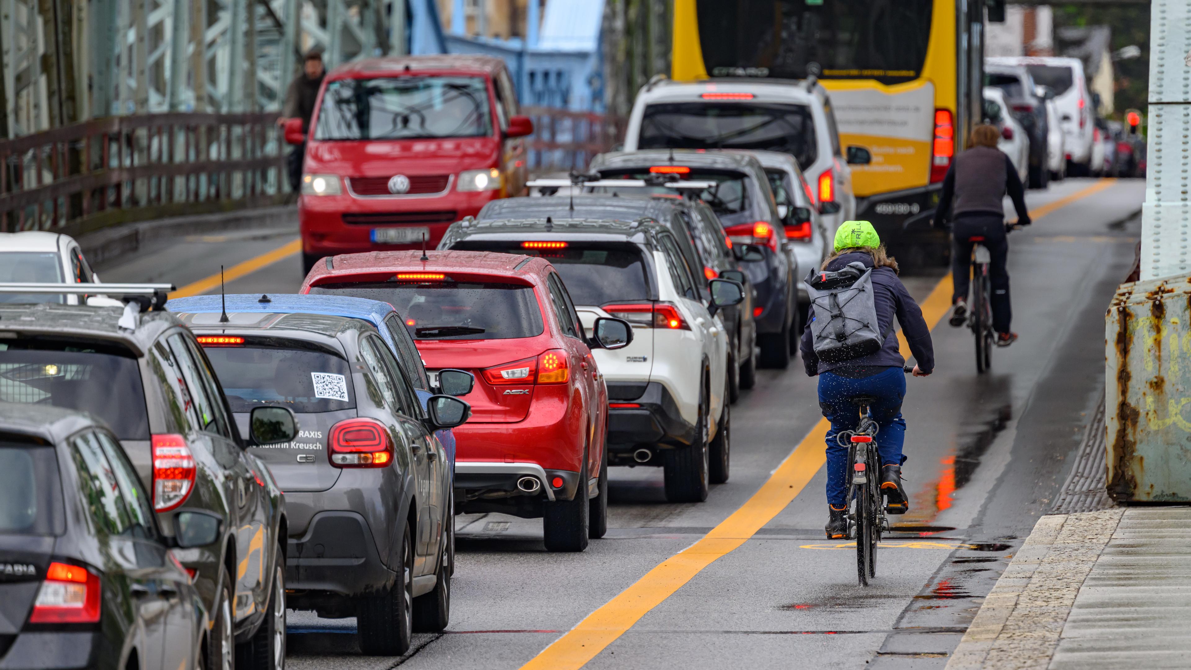 Radfahrer zwischen Blech und Bordstein: Radeln in der Stadt heißt durchzwängen, ausweichen und hoffen, nicht übersehen zu werden.