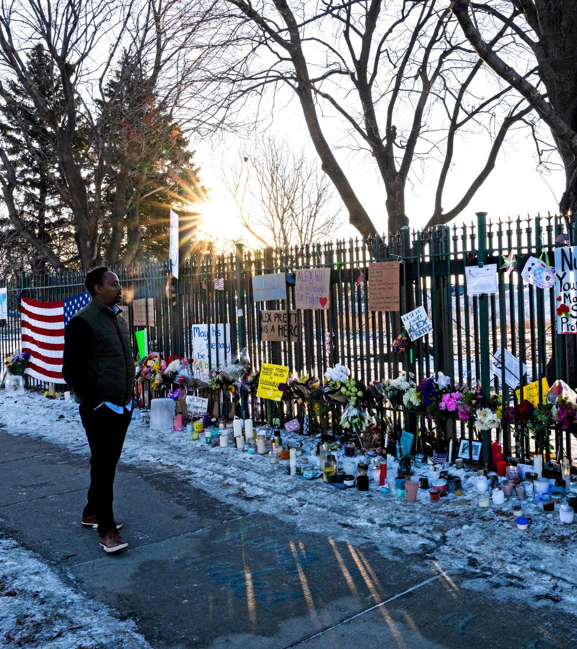 A man stops to look at the memorial for Alex Pretti on the fence line outside the VA Medical Center on January 28, 2026 in Minneapolis, Minnesota