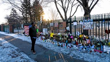 A man stops to look at the memorial for Alex Pretti on the fence line outside the VA Medical Center on January 28, 2026 in Minneapolis, Minnesota