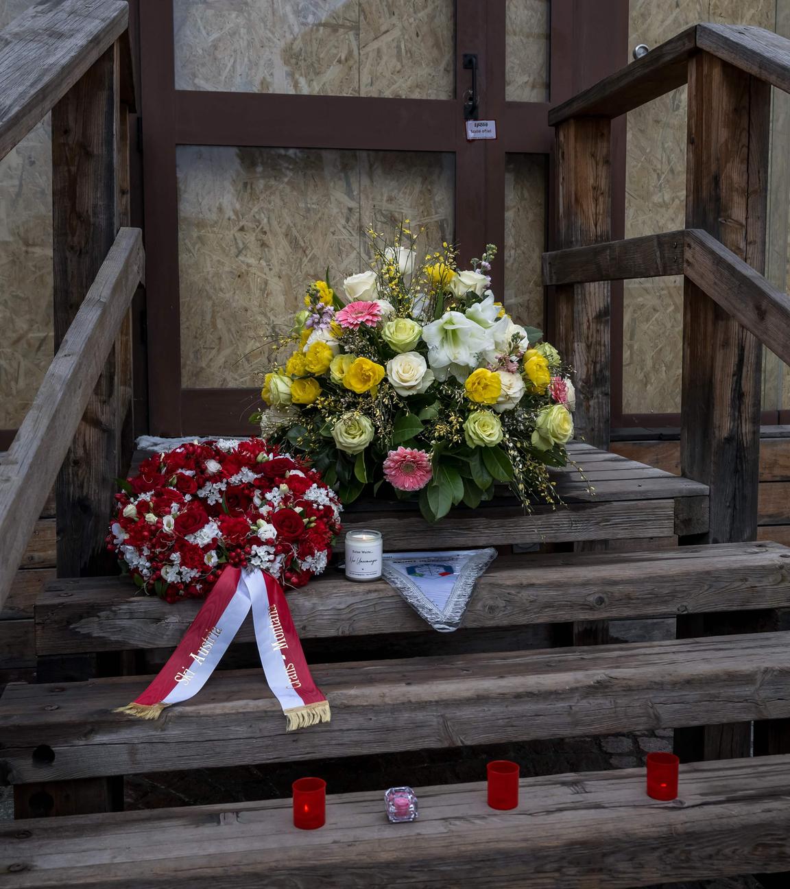 This photograph shows flowers left by members of the Italy's and Autria's alpine ski team - which take part in the World Cup races in Crans Montana - in front of the bar "Le Constellation" to pay tribute to the victims of the fire that ripped through the venue on New Year's Eve celebrations, in the Alpine ski resort of Crans-Montana on January 29, 2026. The fire on January 1 at the bar "Le Constellation" left 40 people dead -- including nine French and six Italian nationals -- and injured 116 others, most of them teenagers.