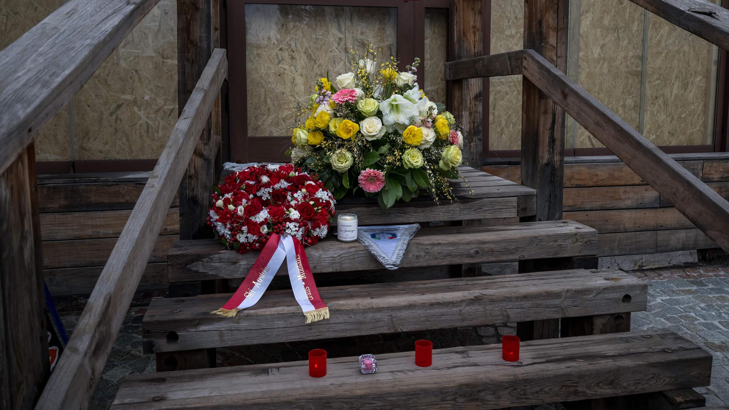 This photograph shows flowers left by members of the Italy's and Autria's alpine ski team - which take part in the World Cup races in Crans Montana - in front of the bar "Le Constellation" to pay tribute to the victims of the fire that ripped through the venue on New Year's Eve celebrations, in the Alpine ski resort of Crans-Montana on January 29, 2026. The fire on January 1 at the bar "Le Constellation" left 40 people dead -- including nine French and six Italian nationals -- and injured 116 others, most of them teenagers.