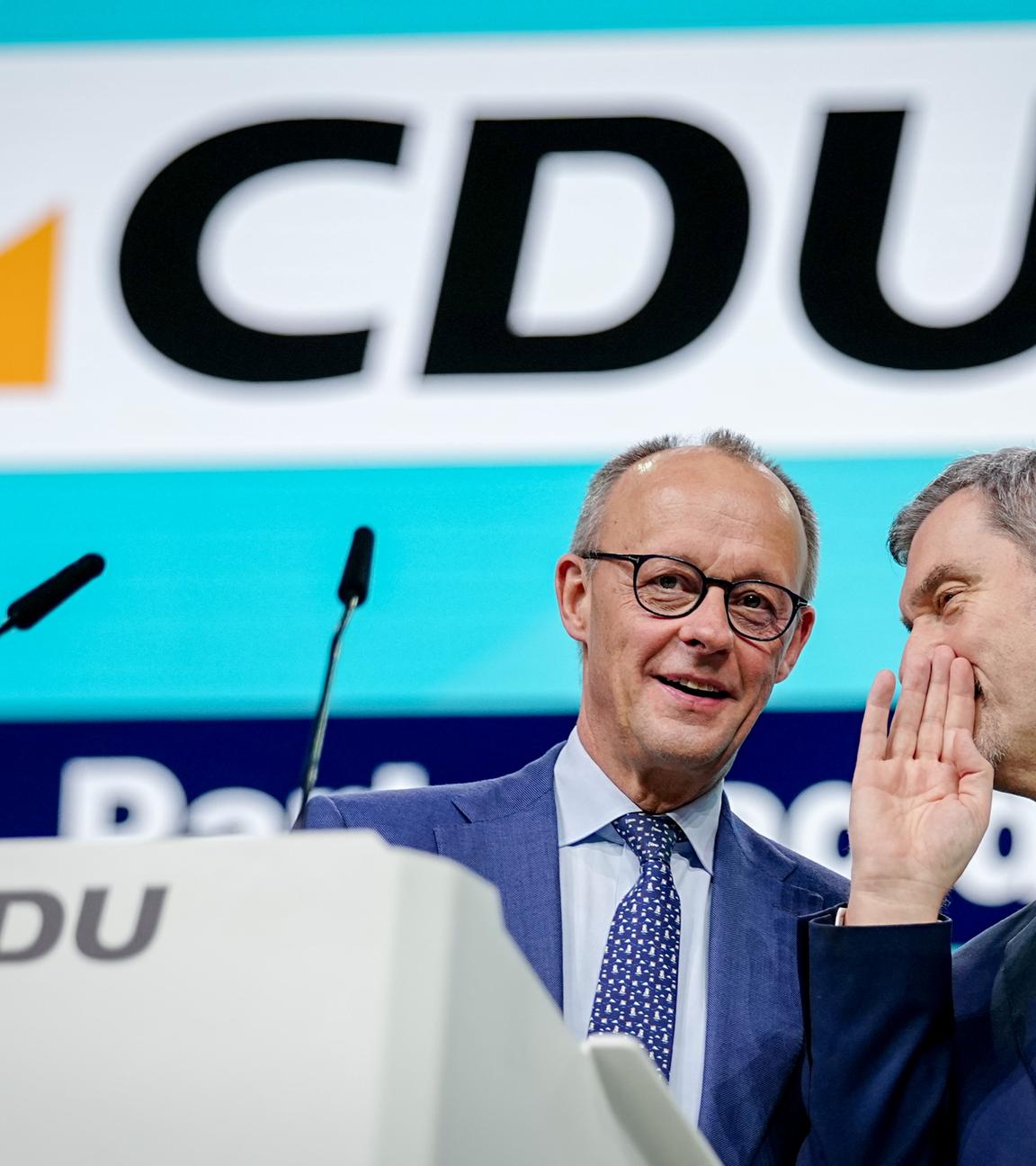 21.02.2026, Baden-Württemberg, Stuttgart: Bundeskanzler Friedrich Merz (l, CDU) und Markus Söder, CSU-Vorsitzender und Ministerpräsident von Bayern, stehen beim CDU-Bundesparteitag auf der Bühne. Nach den Vorstandswahlen geht es am zweiten Tag des Parteitags um die Inhalte. Unter anderem stehen Anträge zu Teilzeit, Einschränkung der Social-Media-Nutzung für Kinder und zur Rentenreform zur Beratung an.