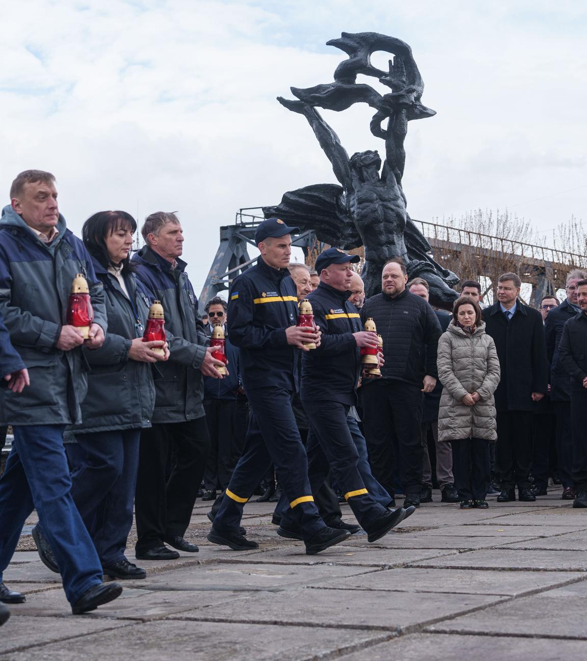 26.04.2026, Ukraine, Tschernobyl: Arbeiter und Retter nehmen an einer Gedenkfeier in der Allee der Liquidatoren teil, die vor 40 Jahren im Kernkraftwerk Tschernobyl ihr Leben verloren haben, Ukraine. Tschernobyl ist der ukrainische Name für die Stadt.