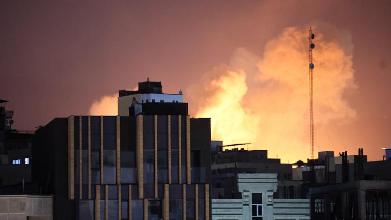 Smoke and flames rise behind buildings after an explosion on the second consecutive day of strikes by the US and Israel, in Tehran, Iran, 01 March 2026. A joint Israeli and US military operation continues on its second day after targeting multiple locations across Iran in the early hours of 28 February 2026, with Iran later launching retaliatory attacks.
