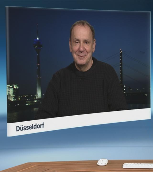 Schaltgespräch zwischen dem Moderator Christian Sievers und dem Karnevalswagenbauer Jascques Tilly