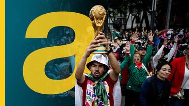 Ein mexikanischer Fußballfan hebt einen WM-Pokal in die Höhe