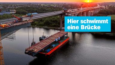 Hier schwimmt eine Brücke; Die Rader Hochbrücke wird bei Sonnenaufgang fertiggestellt.