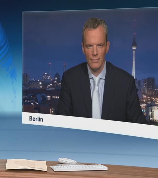 Schaltgespräch zwischen dem Moderator Heinz Wolf und dem Wirtschaftsexperten Florian Neuhann