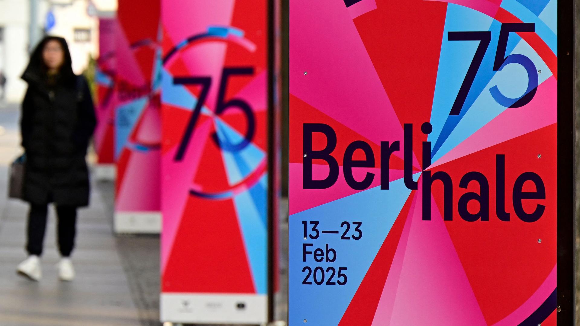 Ein Fußgänger geht an einer Reihe von Berlinale-Plakaten vorbei, während die Vorbereitungen für die 74. Ausgabe der Internationalen Filmfestspiele am 12. Februar 2025 in Berlin im Gange sind. Die 75. Ausgabe des Festivals findet vom 13. bis 23. Februar 2025 statt.