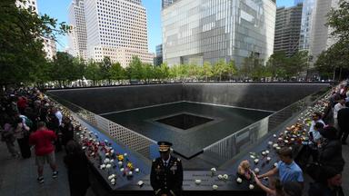 People gather at the memorial during the 25th anniversary commemoration of the September 11, 2001 attacks at the National September 11 Memorial in New York on September 11, 2026. 