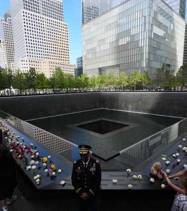People gather at the memorial during the 25th anniversary commemoration of the September 11, 2001 attacks at the National September 11 Memorial in New York on September 11, 2026. 