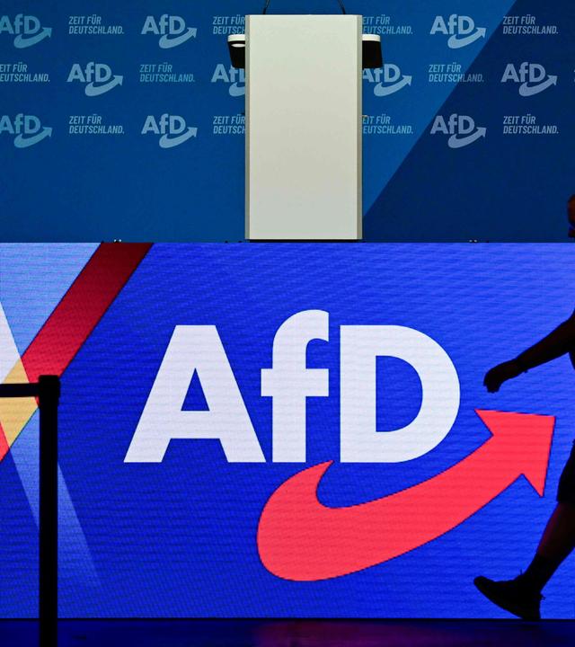 Ein Mann läuft auf einer Bühne einer AfD-Veranstaltung.