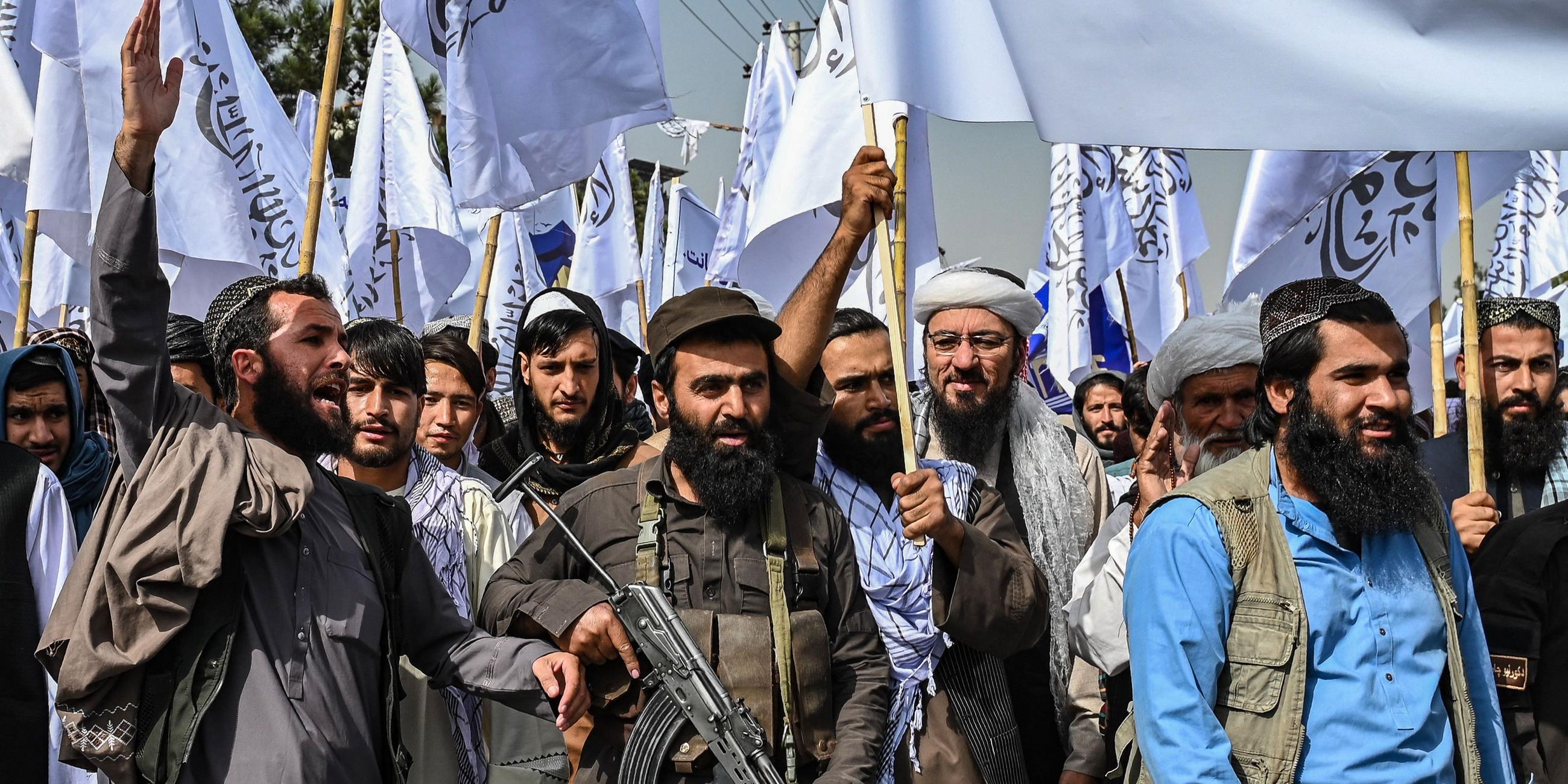 Taliban personnel shout slogans as they celebrate the fourth anniversary of their takeover of Afghanistan near the Kabul Polytechnic University in Kabul on August 15, 2025.