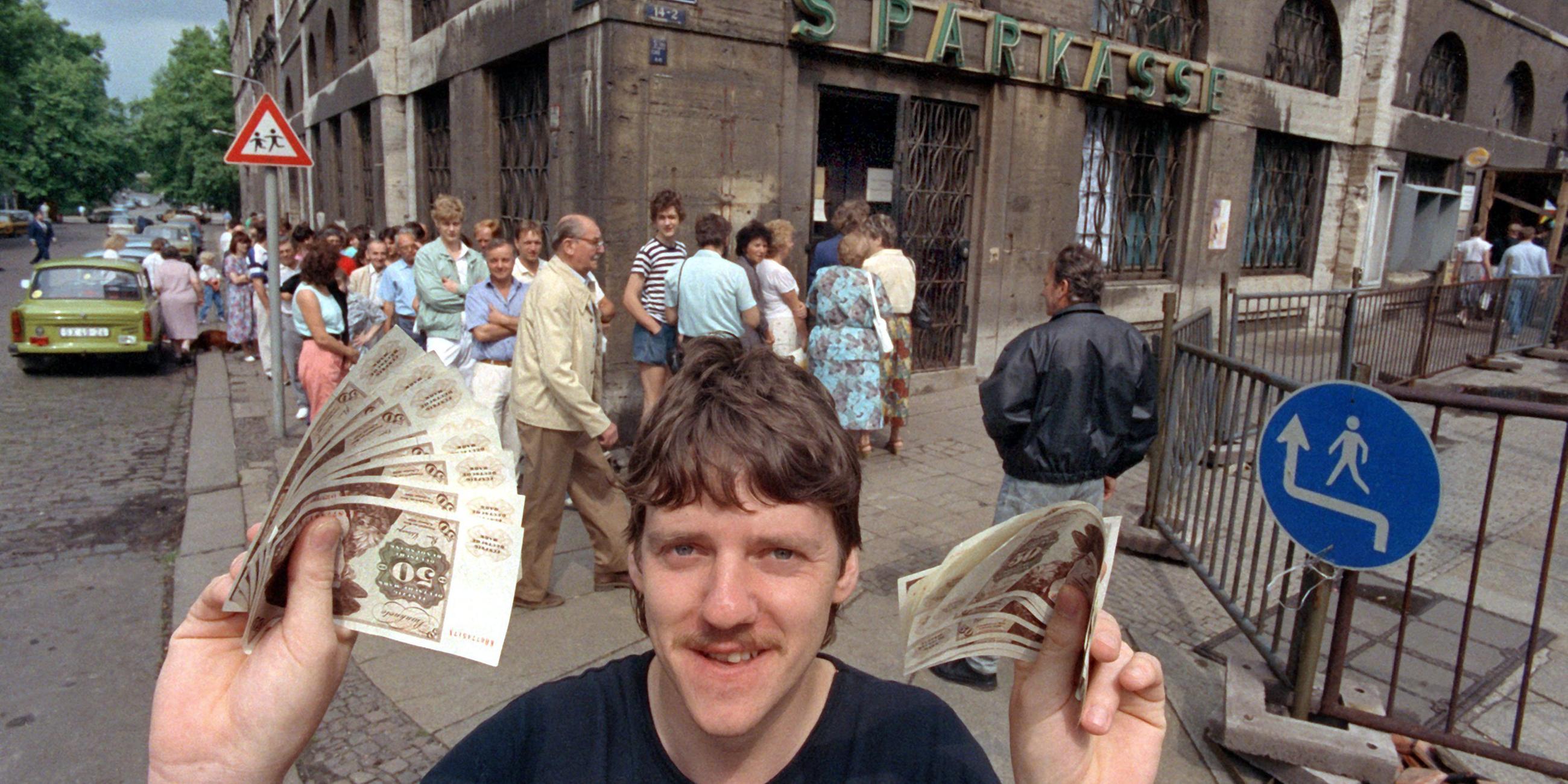 mann mit d-mark-scheinen nach einfuehrung der d-mark in der ddr