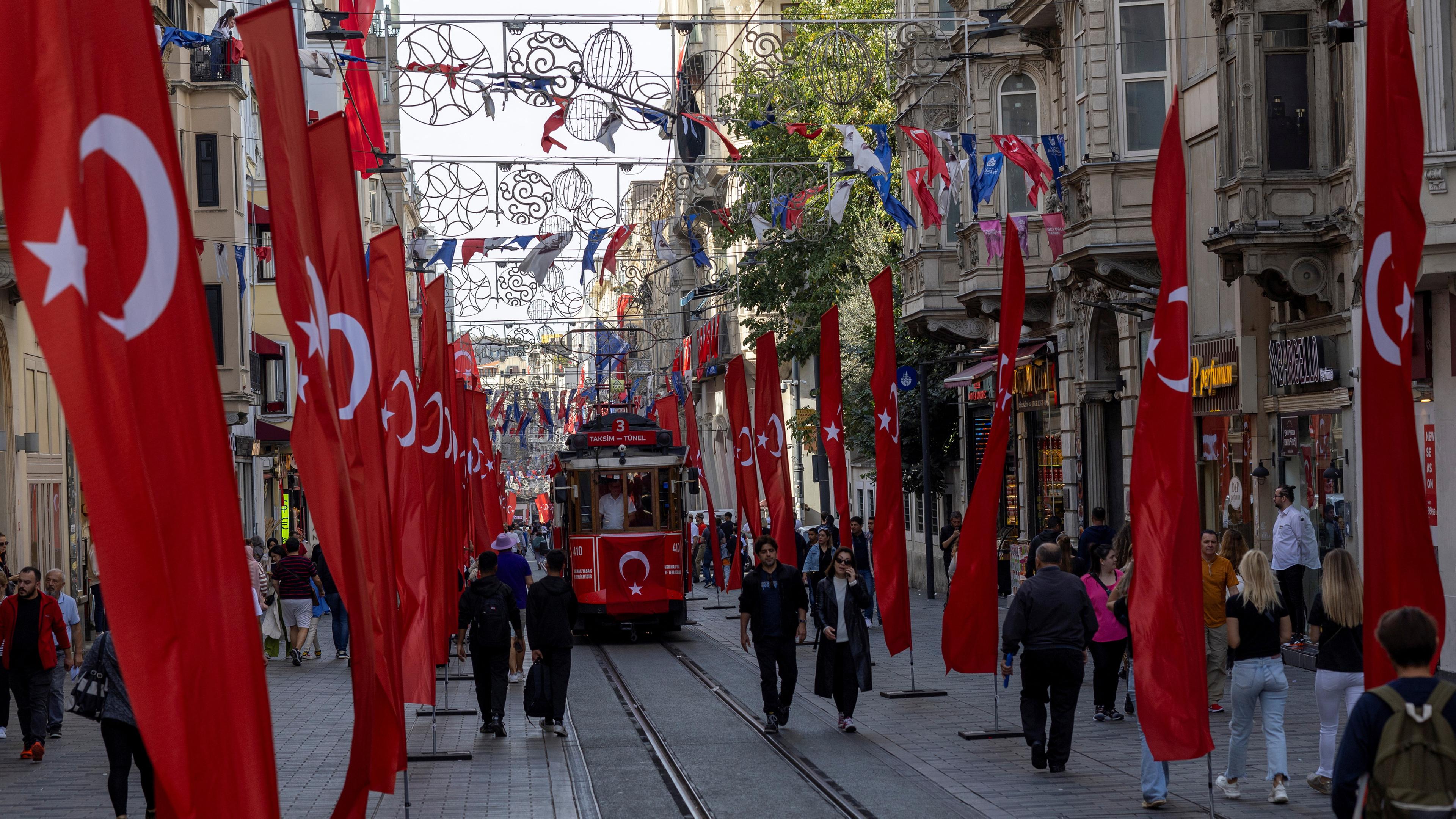 People walk along Istiklal Avenue in Istanbul