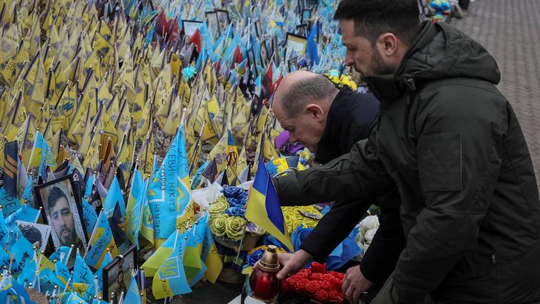 Ukraine's President Zelenskiy and German Chancellor Scholz visit makeshift memorial in Kyiv