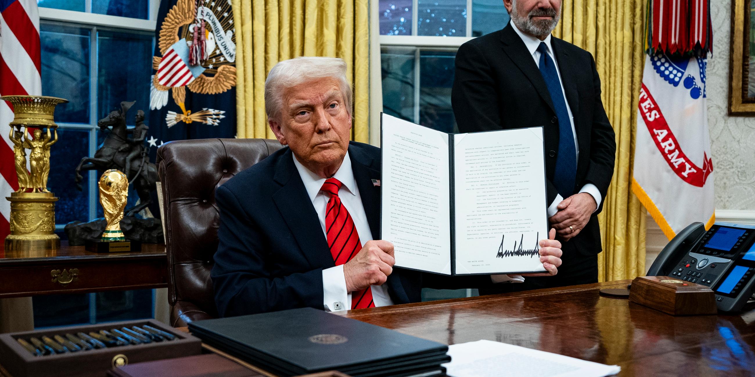 US President Trump signs executive order in Oval Office