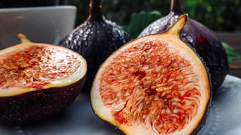 Delicate Fresh Ripe Figs With Leaves On White Plate, Rustic Wooden Table. Ficus