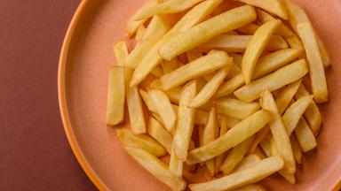 French fries, chips or snack with sauce as food background. French fries