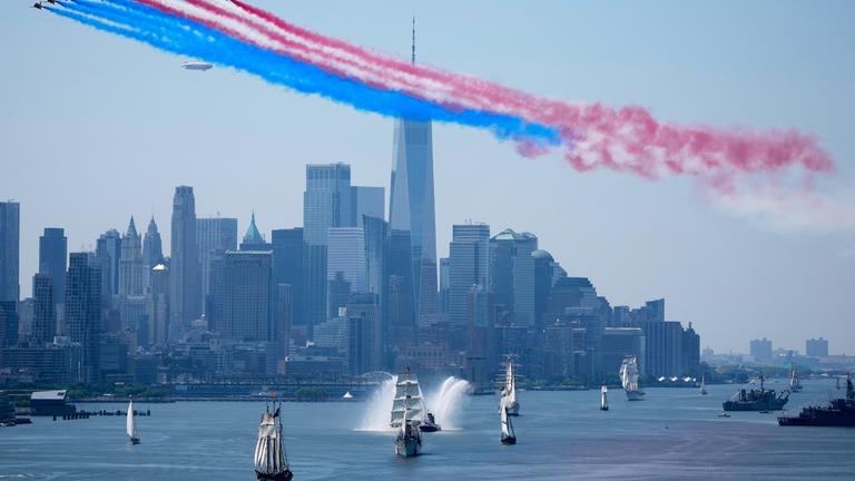 Mehrere große Segelschiffe vor der Skyline von New York. 