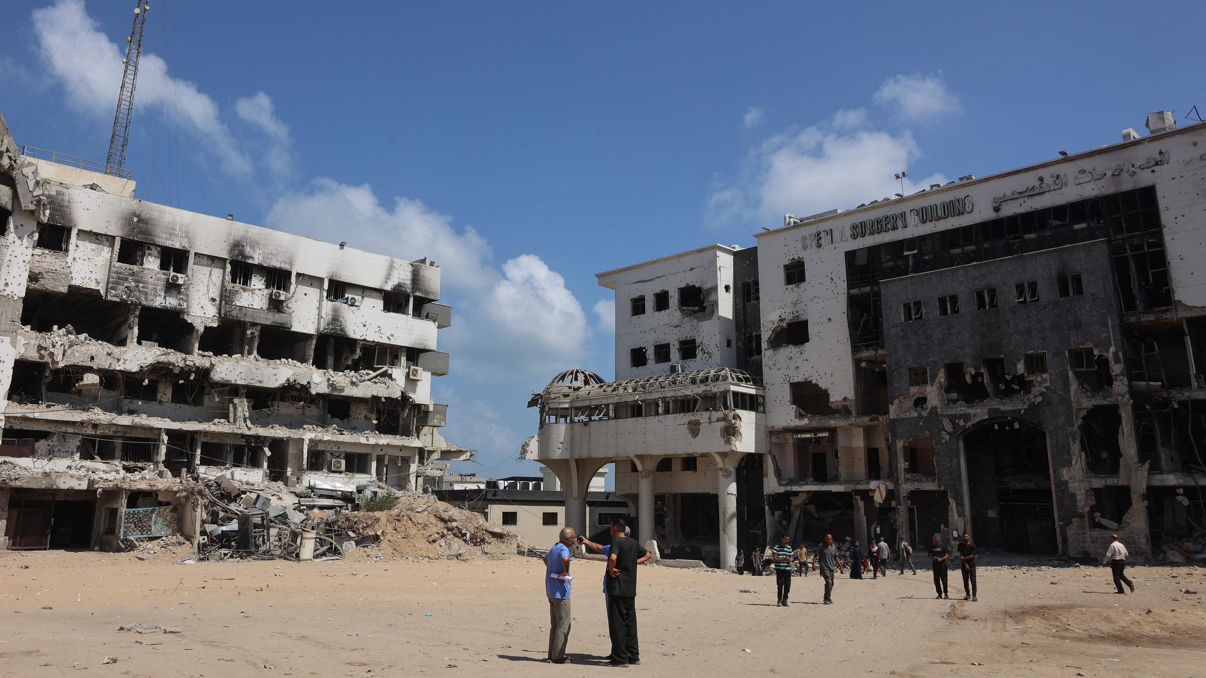 Menschen stehen am 26. August 2025 auf dem Gelände des zerstörten Al-Shifa-Krankenhauses in Gaza-Stadt, inmitten des anhaltenden Krieges zwischen Israel und der militanten palästinensischen Hamas-Gruppe.
